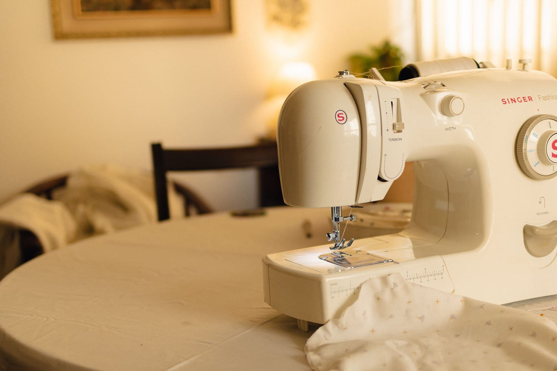 A domestic sewing machine on a table - a stand-in for the Brother SE1900, not a photograph of this model